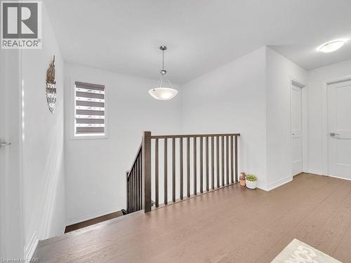 Hallway with wood finished floors and an upstairs landing - 30 Times Square Boulevard, Hamilton, ON - Indoor Photo Showing Other Room