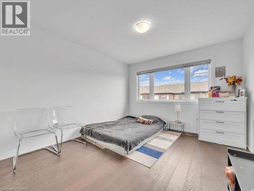 Bedroom featuring wood-type flooring and baseboards - 30 Times Square Boulevard, Hamilton, ON - Indoor Photo Showing Bedroom