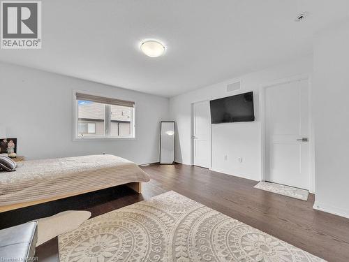 Bedroom with dark wood-type flooring and baseboards - 30 Times Square Boulevard, Hamilton, ON - Indoor Photo Showing Bedroom