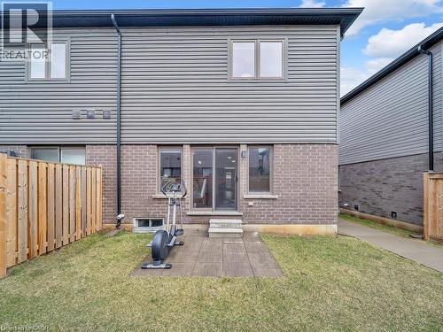 Back of house with a fenced backyard, brick siding, and entry steps - 30 Times Square Boulevard, Hamilton, ON - Outdoor