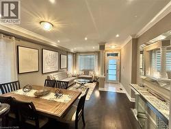 Dining room with crown molding, dark wood finished floors, and recessed lighting - 
