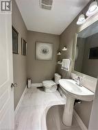 Bathroom featuring baseboards and light marble finish floors - 