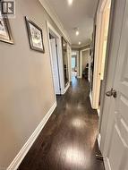 Hall featuring crown molding and dark wood-style flooring - 