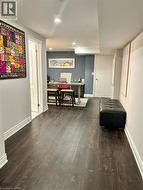 Corridor featuring a desk, dark wood finished floors, and recessed lighting - 
