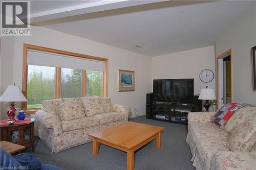 Large family room with wood fireplace. - 546299 Sideroad 4B, Kimberley, ON - Indoor Photo Showing Living Room