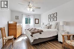 Bedroom with hardwood / wood-style floors and a ceiling fan - 