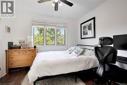 Bedroom featuring dark wood-style floors and ceiling fan - 