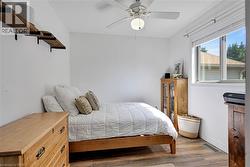 Bedroom featuring wood finished floors and ceiling fan - 