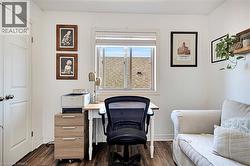 Office space featuring dark wood-style flooring - 