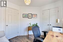 Office space with dark wood-style floors and baseboards - 