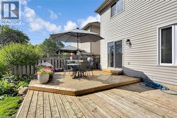 Wooden terrace with outdoor dining space and a gazebo - 
