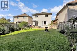 Rear view of house featuring a fenced backyard, a gazebo, and a deck - 