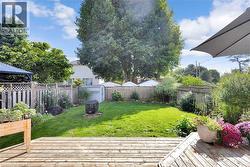 Fenced backyard featuring a deck - 