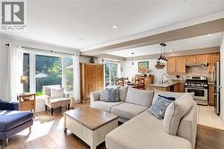 Living room with crown molding, recessed lighting, a textured ceiling, and light wood-type flooring - 
