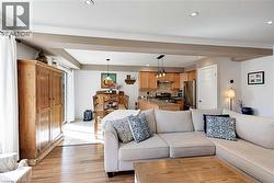 Living room featuring recessed lighting, light wood-style flooring, and crown molding - 