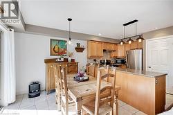 Dining space with light tile patterned flooring and recessed lighting - 