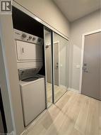 Stacked Washer/Dryer behind Mirrored Closet Doors - 