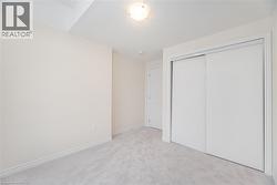 Unfurnished bedroom featuring light carpet and a closet - 