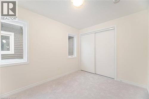 Unfurnished bedroom with light colored carpet and a closet - 109 Molozzi Street, Erin, ON - Indoor Photo Showing Other Room