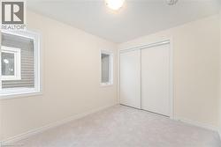 Unfurnished bedroom with light colored carpet and a closet - 