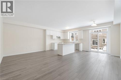 Unfurnished living room featuring light hardwood / wood-style flooring - 109 Molozzi Street, Erin, ON - Indoor Photo Showing Kitchen