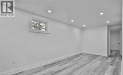 Living room with light wood finished floors and recessed lighting - 