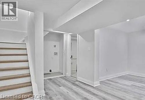 Finished basement featuring stairs and light wood-style floors - 549 Waterloo Street, Hamilton, ON - Indoor Photo Showing Other Room