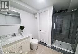 Bathroom with vanity, a stall shower, and light tile patterned flooring - 