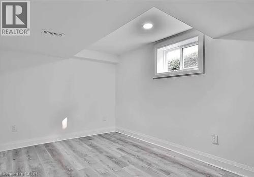 Bedroom 2 with light wood-style flooring and baseboards - 549 Waterloo Street, Hamilton, ON - Indoor Photo Showing Other Room