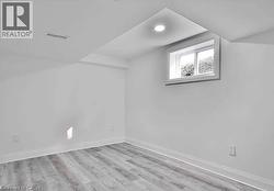 Bedroom 2 with light wood-style flooring and baseboards - 