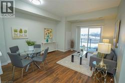 Living room featuring dark wood finished floors and baseboards - 