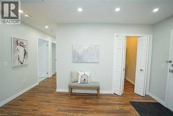 Hallway with recessed lighting and dark wood-style flooring - 