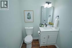Bathroom with vanity and dark wood-type flooring - 