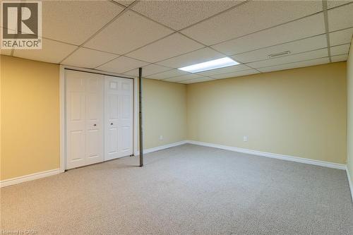 Finished below grade area with light colored carpet and a drop ceiling - 58 Romy Crescent, Thorold, ON - Indoor Photo Showing Basement