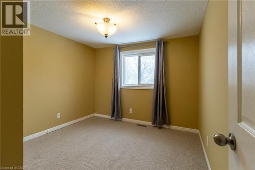 Carpeted spare room with a textured ceiling and baseboards - 58 Romy Crescent, Thorold, ON - Indoor Photo Showing Other Room