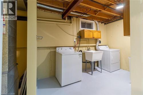 Laundry room with concrete flooring, washer and dryer, and cabinet space - 58 Romy Crescent, Thorold, ON - Indoor Photo Showing Laundry Room