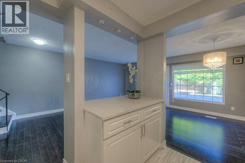 Kitchen featuring white cabinetry, a textured ceiling, light stone counters, pendant lighting, and light wood-style floors - 46 Guerin Avenue, Kitchener, ON - Indoor Photo Showing Other Room