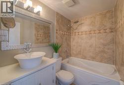 Bathroom with vanity and shower / bathtub combination - 