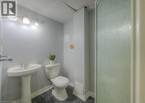 Bathroom with dark tile patterned floors and a stall shower - 46 Guerin Avenue, Kitchener, ON - Indoor Photo Showing Bathroom
