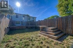 Fenced backyard with a deck - 
