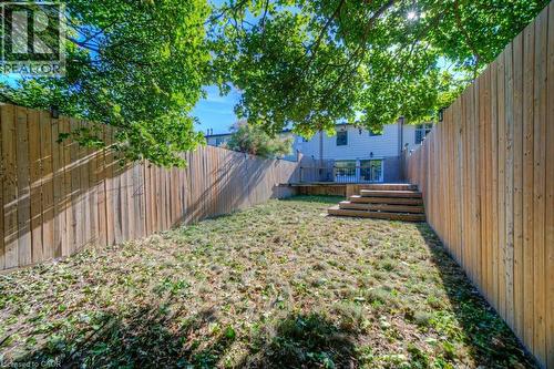 Fenced backyard with a wooden deck - 46 Guerin Avenue, Kitchener, ON - Outdoor