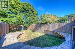 Fenced backyard with a wooden deck - 