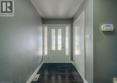 Doorway featuring wood finish floors and a textured ceiling - 46 Guerin Avenue, Kitchener, ON - Indoor Photo Showing Other Room