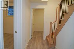 Hall with light wood finished floors and stairway - 