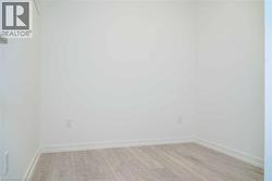 Unfurnished room with light wood-style floors and baseboards - 