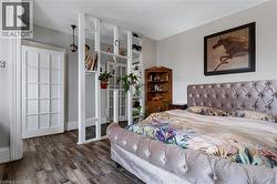 Bedroom with wood finished floors and baseboards - 