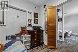 Bedroom featuring wood finished floors and baseboards - 