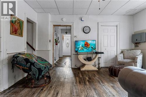 Living area with hardwood / wood-style floors and a paneled ceiling - 193 Locke Street N, Hamilton, ON - Indoor