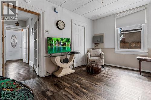 Sitting room featuring wood finished floors and a drop ceiling - 193 Locke Street N, Hamilton, ON - Indoor Photo Showing Other Room