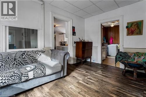 Living area featuring a drop ceiling, wood finished floors, and a ceiling fan - 193 Locke Street N, Hamilton, ON - Indoor
